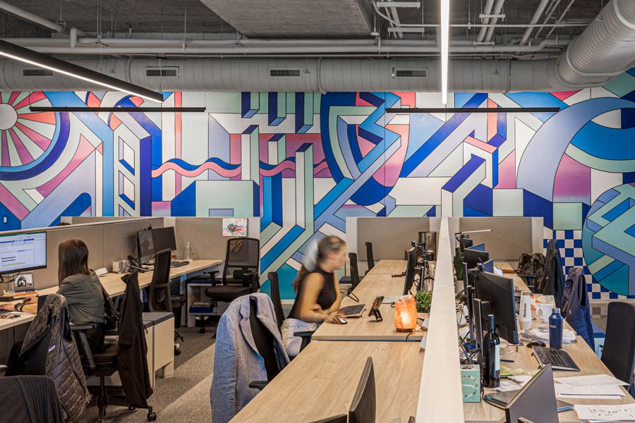 Stream Realty Partners workspace with mural in the background